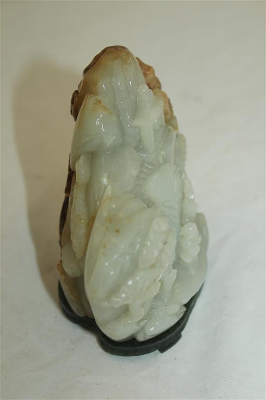 A Chinese pale celadon and russet jade boulder carving, height 10cm